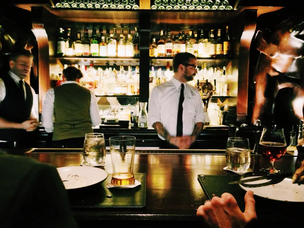 A bartender getting ready behind the bar