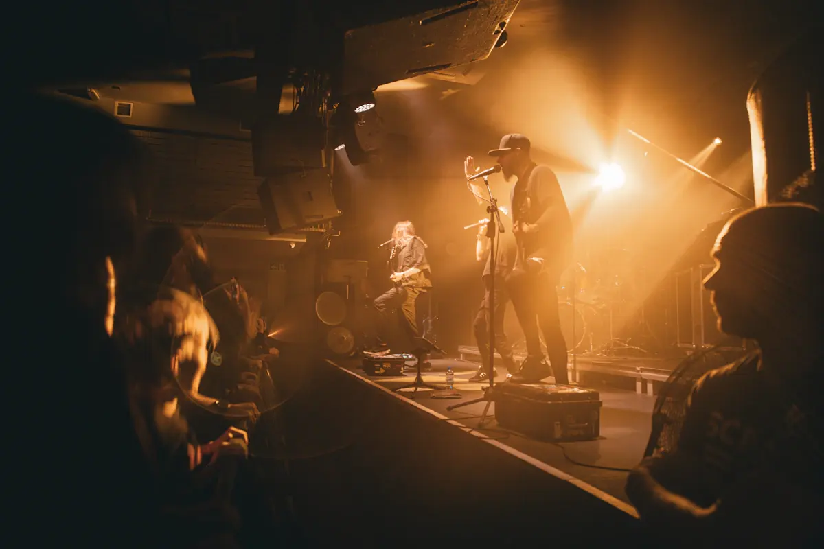 Musicians performing together under stage spotlights