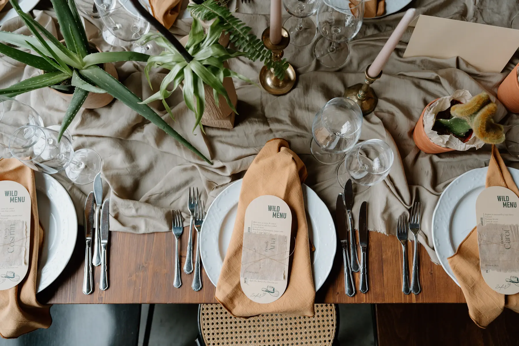 Linen, glassware and printed menus on a table set for guests