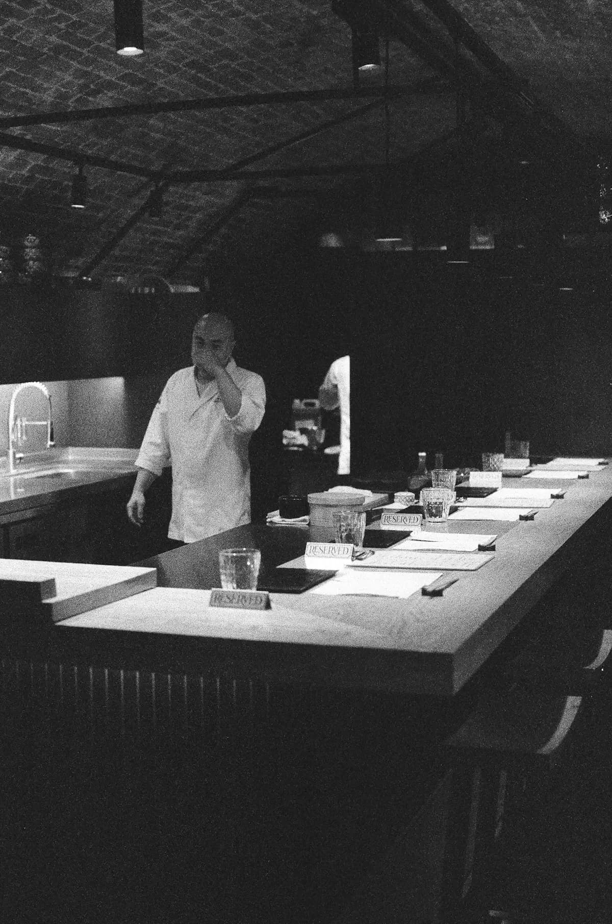 A chef preparing food at the kitchen counter
